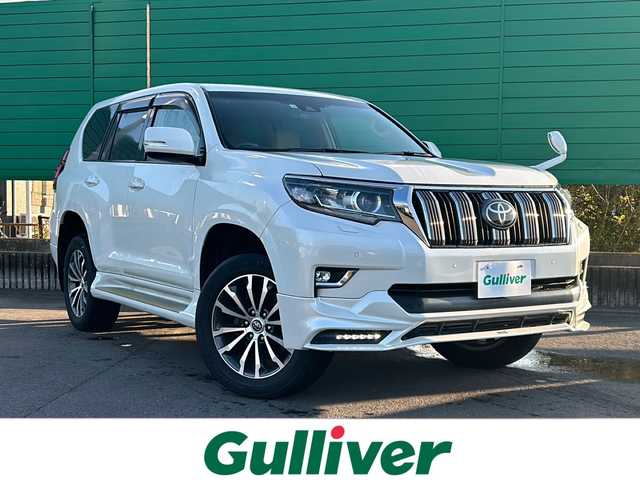 トヨタ ランドクルーザー プラド TX Lパッケージ 福岡県 2017(平29)年 5.8万km ホワイトパールクリスタルシャイン 寒冷地仕様/純正TRDエアロ/TRDマフラー/純正9インチナビ(CD.DVD.SD.USB)/フルセグテレビ/バックカメラ/サンルーフ/ルーフレール/トヨタセーフティセンス/クリアランスソナー/レーダークルーズコントロール/ETC/オートハイビーム/レザーシート/パワーシート/シートヒーター/純正19インチAW