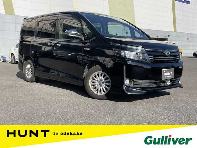 トヨタ ヴォクシー ハイブリッド V 千葉県 2015(平27)年 14.4万km ブラック ユーザー買取車両/クリアランスソナー/純正9インチナビ/・フルセグ/BT/DVD/CD/バックカメラ/ステアリングスイッチ/ETC/両側パワースライドドア/LEDヘッドライト/オートライト/スマートキー/プッシュスタート/電動格納ミラー