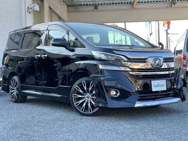 トヨタ ヴェルファイア ハイブリット V 埼玉県 2015(平27)年 13.2万km 黒 ・社外エアロ/・ワーク20インチアルミ/・純正ナビ　BT/TV/・後席モニター/・バック＆フロントカメラ/・ETC/・ドライブレコーダー/・電動パーキング/・両側パワースライドドア/・電動リアゲート/・ブレーキホールド/・ステアリングスイッチ/・レーダークルコン/・衝突軽減ブレーキ/・横滑り防止/・オットマン/・前席パワーシート/・シートメモリー/・純正フロアマット/・ドアバイザー/・ウッドコンビステアリング/・スマートキー×２/・プッシュスタート/・保証書/・取説