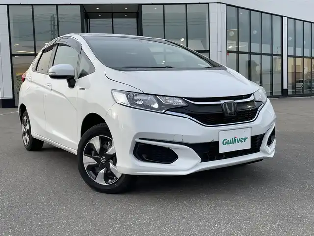 ホンダ フィット ハイブリット F 青森県 2019(令1)年 8.2万km タフタホワイトⅢ ・4WD/・禁煙車/・社外SDナビ/AM/FM/・Bluetooth/・衝突被害軽減ブレーキ/・クルーズコントロール/・バックカメラ/・レーンキープアシスト/・盗難防止装置/・横滑り防止装置/・スマートキー/・スペアキー/・HIDライト/・ダブルエアバック/・社外フロアマット/・ETC/・冬タイヤ/・取扱説明書