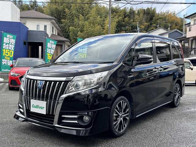 トヨタ エスクァイア ハイブリッド Gi 熊本県 2014(平26)年 8万km ブラック ワンオーナー/純正ナビ（NSZT-Y64T）/【フルセグ/CD/DVD/Bluetooth/ラジオ】/バックカメラ/両側パワースライドドア/純正フリップダウンモニター/クルーズコントロール/トラクションコントロール/先行車発進お知らせ機能/黒革シート/前席シートヒーター/ビルトインETC/社外17インチAW/オートライト/LEDヘッドライト/フォグランプ/置くだけ充電/純正フロアマット/純正ドアバイザー/ウッドコンビステアリング/保証書/取扱説明書