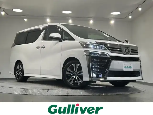 トヨタ ヴェルファイア Z Gエディション 愛知県 2018(平30)年 4.2万km ホワイトパールクリスタルシャイン 純正１０型Ｔコネクトナビ/(AM/FM/CD・DVD再生/フルセグTV/SD/Bluetooth)/バックカメラ/ツインムーンルーフ　/ＡＣ１００Ｖコンセント　/純正フリップダウンモニター　/デジタルインナーミラー　/ビルトインＥＴＣ２．０　/トヨタセーフティセンス　/　　-プリクラッシュセーフティ/　　-レーントレーニングアシスト（LTA)/　　-レーダークルーズコントロール（ACC)/　　-ロードサインアシスト（RSA)/　　-アダプティブハイビームシステム/両側パワースライドドア　/電動リアゲード　/シートヒーター/エアシート/オートブレーキホールド機能/クリアランスソナー