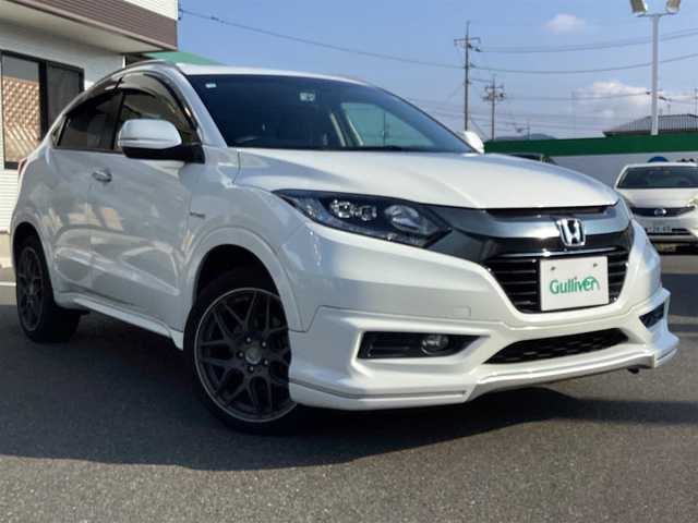 ホンダ ヴェゼル ハイブリッド Z 岡山県 2014(平26)年 6万km ホワイトオーキッドパール 純正ナビ/Bluetooth/フルセグTV/バックカメラ/ETC/ハーフレザーシート/Ｄ/Ｎシートヒーター/ドラレコ/社外18ＡＷ/LEDヘッドライト/オートライト/衝突軽減ブレーキ/クルーズコントロール/パドルシフト/スマートキー/プッシュスタート