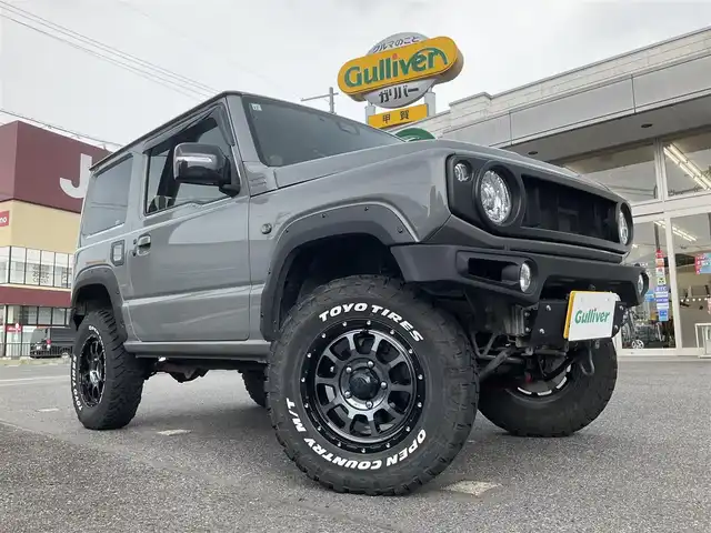 スズキ ジムニー XC 滋賀県 2021(令3)年 4.3万km ミディアムグレー 純正9インチナビゲーション/・Bluetooth・フルセグTV/FRPボンネット/FRバンパー（ショウワガレージ）/スキッドプレート（ショウワガレージ）/マフラー（ショウワガレージ）/テールランプ（ショウワガレージ）/フロントグリル（ショウワガレージ）/エアクリーナー（GReddy)/ブローオフバルブ（GReddy)/インタークーラ（GReddy)/シャックアブソーバー14段階調節式（タニグチ）/サスペンションスプリング/ラテラルロッド/オイルキャッチタンク/HKSブーストコントローラー（powerEditor)/社外フロントカメラ/ブーストメーター（Pivot）/ステアリング（ナルディー）/アルパインデジタルインナーミラー/・前後ドライブレコーダー付き/社外16AW（Toyoオープンカントリー）/ビルトインETC/保証書・取説・スペアキー/