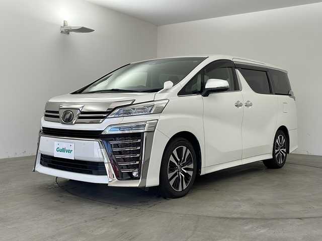 トヨタ ヴェルファイア Z Gエディション 兵庫県 2019(令1)年 6.8万km ホワイトパールクリスタルシャイン ・純正ナビ/Bluetooth/CD/DVD/TV/・バックカメラ/・Toyota Safety Sense/・プリクラッシュセーフティ/・レーントレーシングアシスト［LTA］/・レーダークルーズコントロール（全車速追従機能付）/・ロードサインアシスト［RSA］/・オートマチックハイビーム［AHB］/・先行車発進告知機能［TMN］/・インテリジェントクリアランスソナー/・ドライブスタートコントロール/・パワーバックドア/・電動パーキングブレーキ/・オートホールド/・ステアリングヒーター/・オートワイパー/・前席シートヒーター＆ベンチレーション/・前席パワーシート/・メモリシート/・オットマン/・ウインカーミラー/・自動防眩ミラー/・純正フロアマット/・LEDオートライト/・フォグランプ/・純正18インチアルミホイール/・ビルトインETC/・純正前方ドライブレコーダー/・取扱説明書/・スマートキー