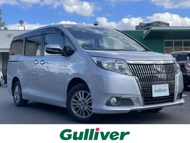 トヨタ エスクァイア Xi 島根県 2015(平27)年 1.3万km シルバーM 純正ＳＤナビ　/Ｂｌｕｅｔｏｏｔｈ/ワンセグTV　/バックカメラ　/ビルトインＥＴＣ　/ドライブレコーダー　/パワースライドドア　/オートライト/純正ＬＥＤライト/純正フロアマット　/純正アルミホイール　/取扱説明書　