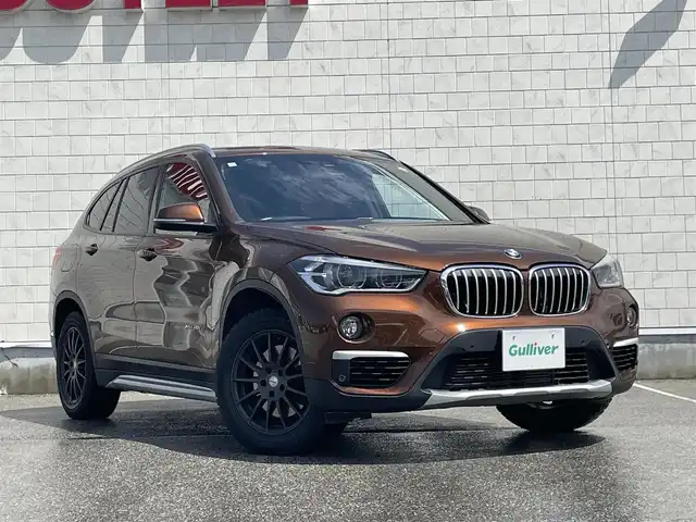 ＢＭＷ Ｘ１ xDrive 20i xライン ハイラインパッケージ 富山県 2015(平27)年 5.6万km 茶 4WD/サンルーフ/純正ナビ/Bluetooth/バックカメラ/衝突被害軽減ブレーキ/コーナーセンサー/レーンキープアシスト/レザーシート/ブラウンレザー調シートカバー/プッシュスタート/スマートキー/革巻きステアリング/シートヒーター/LEDヘッドライト/オートライト/ETC