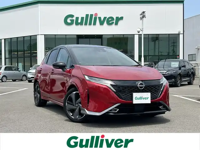 日産 オーラ G レザーエディション 愛媛県 2023(令5)年 2.2万km ガーネットレッド/スーパーブラック 2トーン 登録時走行距離：21270km/禁煙車/純正ナビ/Bluetooth/HDMI/フルセグ/ワンオーナー/ステアリングヒーター/ワイヤレス充電/ブラインドスポットモニター/クリアランスソナー/全方位バックカメラ/クルーズコントロール/プッシュスタート/ビルトインETC/BOSEスピーカー/衝突被害軽減システム/ドライブレコーダー
