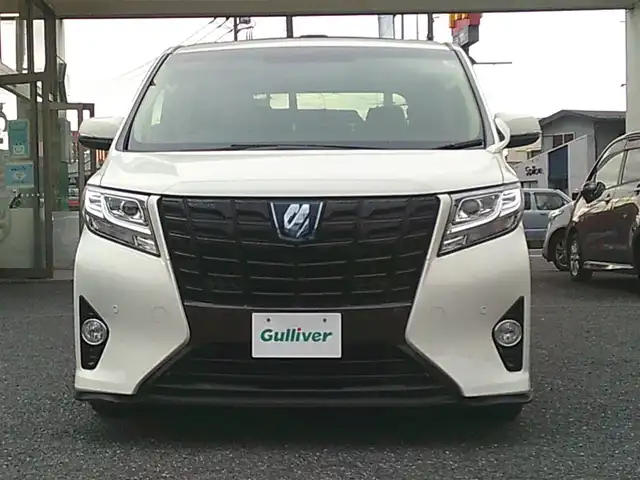 トヨタ アルファードハイブリット X 埼玉県 2015(平27)年 7.2万km ラグジュアリーホワイトパールクリスタルシャインガラスフレーク ・ディーラー記録簿（H27～R7まで完備）/・ワンオーナー/・サンルーフ/・両側パワースライドドア/・クルーズコントロール/・社外・デジタルインナーミラー（前後ドラレコ機能有）/・アルパイン10インチナビ/・アルパイン13インチフリップダウンモニター/・クラリオンフロントスピーカー/・クラリオンリアスピーカー/・カロッツェリア天吊りスピーカー/・アルパインアンプ/・社外・LEDルームランプ/・社外・皮調シートカバー/・社外・シフトゲートLEDイルミランプ/・2列目オットマンシート/・AC１００V電源/・社外・フルカラーLEDフットランプ/・社外・ルーフカラーイルミコントローラー/・TEIN車高調（フレックスZ)/・ロクサーニメイオール21インチアルミ/（９．０J　＋３８）/・コンチネンタルマックスコンタクトタイヤ21インチ/・HIDヘッドライト/・HIDフォグランプ/・社外・スーパーウェルカムライティングキット/・社外・アイドリングライトキット/・社外・アルミスカッフプレート/・社外・ホーン（クラクソンストリトーン）/・スマートキー×２/・プッシュスタート/・保証書/・取説