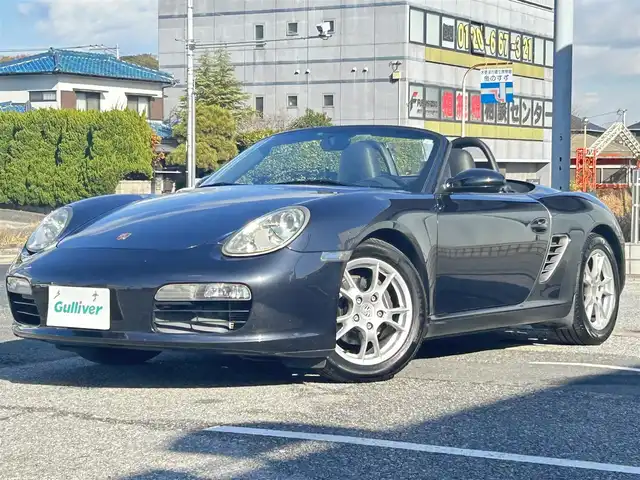 ポルシェ ボクスター 千葉県 2007(平19)年 5万km アトラスグレー 左ハンドル/5速MT/オープンカー/社外ディスプレイオーディオ/・AM/FM/BT/ビルトインETC/シートヒーター（D+N席）/純正フロアマット/アンチロック・ブレーキ・システム/純正17インチアルミホイール/エアバッグ（W+サイド）/保証書/扱説明書