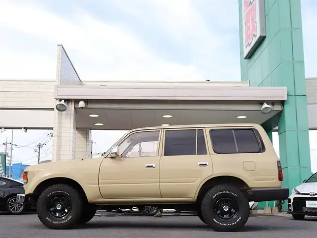 トヨタ ランドクルーザー VX－LTD 神奈川県 1994(平6)年 13.6万km ベージュ 60フェイス（色替え）/リフトアップ/ナローボディ/1ナンバー登録/BF Goodrich All-terrain/：235/85R16（ホワイトレター）/PROUD HORN/社外ウッドステアリング/サンルーフ/メモリナビ/：フルセグTV/：CD DVD再生/：Bluetoothオーディオ/：バックカメラ/社外フロアマット/純正キー/：リモコン有り/ETC/ドラレコ（フロント）/社外シートカバー/ーーーーーーーーーーーーーーーーーーー/取扱説明書