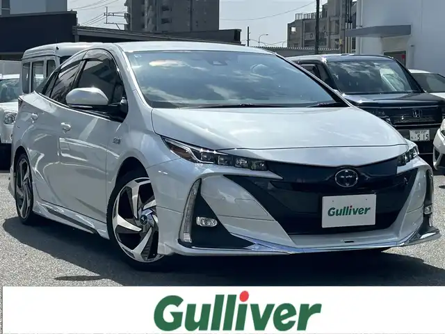 トヨタ プリウス ＰＨＶ A プレミアム 福岡県 2021(令3)年 3.9万km プラチナホワイトパールマイカ 純正メーカーディスプレイオーディオ/（ナビ・フルセグTV・Bluetooth）/JBLプレミアムサウンド/パノラミックビューモニター/トヨタセーフティセンス/シートヒーター/シートクーラー/運転席パワーシート/ブラインドスポットモニター/ワイヤレス充電器/ハンドルヒーター/パーキングアシスト/モデリスタフルエアロ/モデリスタアルミ18インチ/2.0ビルトインETC/ウィンカーミラー/ドアバイザー/純正フロアマット/取扱説明書