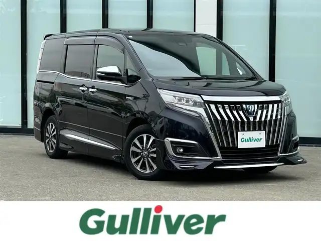トヨタ エスクァイア ハイブリッド Gi プレミアムパッケージ 大阪府 2018(平30)年 6.1万km スパークリングブラックパールクリスタルシャイン 純正１１インチナビ/   フルセグTV/CD/DVD/Bluetooth/USB/バックモニター/12.1インチ後席モニター/衝突軽減ブレーキ/社外エアロ/純正15インチアルミホイール/前席シートヒーター/シートカバー付き/両側パワースライドドア/クルーズコントロール/レーンキープアシスト/アイドリングストップ/オートマチックハイビーム/ドライブレコーダー/プッシュスタート/スマートキー/ＥＴＣ/ＬＥＤライト/禁煙車
