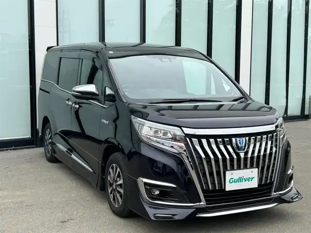 トヨタ エスクァイア ハイブリッド Gi プレミアムパッケージ 大阪府 2018(平30)年 6.1万km スパークリングブラックパールクリスタルシャイン 純正１１インチナビ/   フルセグTV/CD/DVD/Bluetooth/USB/バックモニター/12.1インチ後席モニター/衝突軽減ブレーキ/社外エアロ/純正15インチアルミホイール/前席シートヒーター/シートカバー付き/両側パワースライドドア/クルーズコントロール/レーンキープアシスト/アイドリングストップ/オートマチックハイビーム/ドライブレコーダー/プッシュスタート/スマートキー/ＥＴＣ/ＬＥＤライト/禁煙車