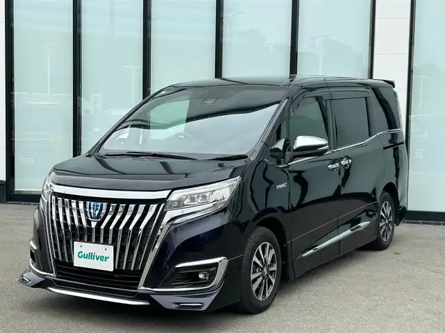 トヨタ エスクァイア ハイブリッド Gi プレミアムパッケージ 大阪府 2018(平30)年 6.1万km スパークリングブラックパールクリスタルシャイン 純正１１インチナビ/   フルセグTV/CD/DVD/Bluetooth/USB/バックモニター/12.1インチ後席モニター/衝突軽減ブレーキ/社外エアロ/純正15インチアルミホイール/前席シートヒーター/シートカバー付き/両側パワースライドドア/クルーズコントロール/レーンキープアシスト/アイドリングストップ/オートマチックハイビーム/ドライブレコーダー/プッシュスタート/スマートキー/ＥＴＣ/ＬＥＤライト/禁煙車