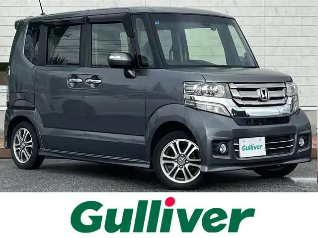 ホンダ Ｎ ＢＯＸ カスタム G Lパッケージ 滋賀県 2015(平27)年 4.9万km ポリッシュドメタルメタリック 両側パワースライドドア/社外7インチナビ【VXM-152VFi】/（AM/FM/CD/DVD/ワンセグ/Bluetooth/USB）/ドライブレコーダー/バックカメラ/ホンダセンシング/・プリクラッシュブレーキアシスト/・ヒルスタート（坂道発進）アシスト/・TCS（トラクションコントロールシステム）/・VDC（ビークルダイナミクスコントロール）/・ABS（アンチロックブレーキシステム）/・バックビューモニター/・盗難防止アラーム	/電動格納ミラー/アイドリングストップ/ステアリングスイッチ/オートライト/キセノンヘッドライト/フロントフォグ/フルオートエアコン/シガーソケット/プッシュスタート/スマートキー/純正フロアマット/純正ドアバイザー