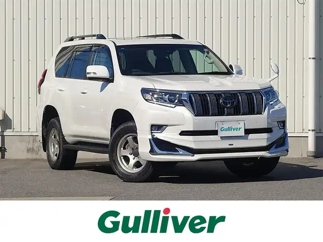 トヨタ ランドクルーザー プラド TX Lパッケージ 山形県 2022(令4)年 2.7万km ホワイトパールクリスタルシャイン ワンオーナー車/4WD/サンルーフ/7人乗り/MODELLISTAエアロ/セーフティセンス/レザーシート/パワーシート/シートヒーター/エアシート/横滑り防止装置/純正オーディオ/　【CD USB AUX】/コーナーセンサー/LEDライト/フォグランプ/ウィンカーミラー/純正フロアマット/純正ドアバイザー/保証書、取説あり