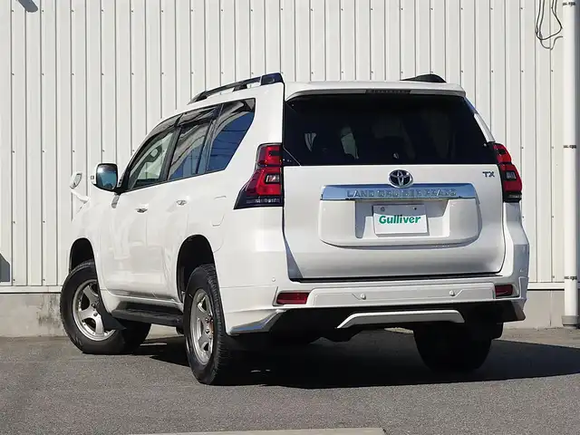 トヨタ ランドクルーザー プラド TX Lパッケージ 山形県 2022(令4)年 2.7万km ホワイトパールクリスタルシャイン ワンオーナー車/4WD/サンルーフ/7人乗り/MODELLISTAエアロ/セーフティセンス/レザーシート/パワーシート/シートヒーター/エアシート/横滑り防止装置/純正オーディオ/　【CD USB AUX】/コーナーセンサー/LEDライト/フォグランプ/ウィンカーミラー/純正フロアマット/純正ドアバイザー/保証書、取説あり