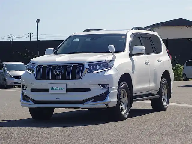 トヨタ ランドクルーザー プラド TX Lパッケージ 山形県 2022(令4)年 2.7万km ホワイトパールクリスタルシャイン ワンオーナー車/4WD/サンルーフ/7人乗り/MODELLISTAエアロ/セーフティセンス/レザーシート/パワーシート/シートヒーター/エアシート/横滑り防止装置/純正オーディオ/　【CD USB AUX】/コーナーセンサー/LEDライト/フォグランプ/ウィンカーミラー/純正フロアマット/純正ドアバイザー/保証書、取説あり