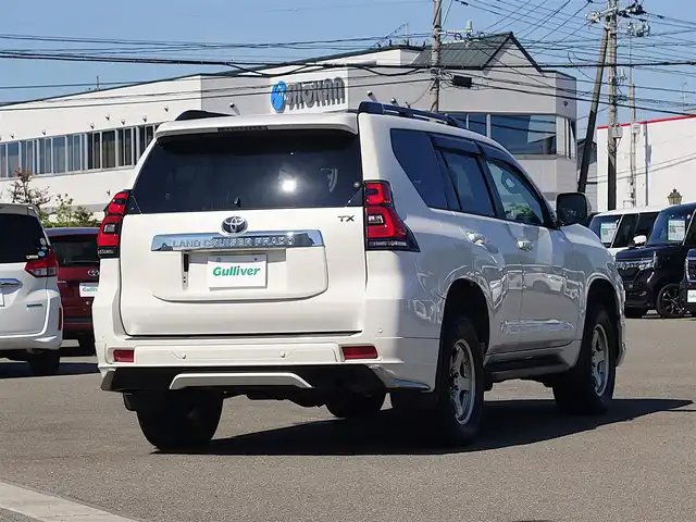 トヨタ ランドクルーザー プラド TX Lパッケージ 山形県 2022(令4)年 2.7万km ホワイトパールクリスタルシャイン ワンオーナー車/4WD/サンルーフ/7人乗り/MODELLISTAエアロ/セーフティセンス/レザーシート/パワーシート/シートヒーター/エアシート/横滑り防止装置/純正オーディオ/　【CD USB AUX】/コーナーセンサー/LEDライト/フォグランプ/ウィンカーミラー/純正フロアマット/純正ドアバイザー/保証書、取説あり