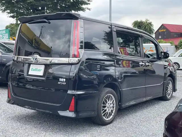 トヨタ ノア ハイブリッド Si ダブルバイビー 埼玉県 2017(平29)年 4.1万km ブラック ワンオーナー/シートヒーター/純正メモリーナビ＆ワンセグＴＶ/（ＤＶＤ＆ＣＤ＆ＢＴ）/フリップダウンモニター/バッックカメラ/ビルトインＥＴＣ（２.０）/純正ドライブレコーダー/トヨタセーフティーセンス/クルーズコントロール/革巻きステアリング/ステアリングリモコン/両側パワースライドドア/純正エアロ/純正１６inアルミホイール/オートハイビーム/オートライト/ＬＥＤライト/フォグランプ/ウィンカーミラー/オート電動格納ミラー/スマートキー/プッシュスタート/Ｗ＆サイド＆カーテンエアバッグ/横滑り防止装置/ＡＢＳ/ドアバイザー/フロアマット/新車保証書/取扱説明書/ナビ取扱説明書/スマートスペアキー有