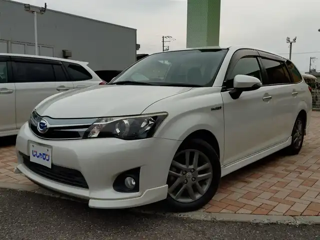 トヨタ カローラ フィールダー HV G エアロツアラー W×B 新潟県 2014(平26)年 10.1万km ホワイトパールクリスタルシャイン (株)IDOMが運営する【じしゃロン新潟店】の自社ローン専用車両になります。/こちらは現金またはオートローンご利用時の価格です。自社ローンご希望の方は別途その旨お申付け下さい/純正ナビ/FM/AM/CD視聴可能/ワンセグTV視聴可能(走行中視聴不可)/Bluetooth/AUX接続可能/バックカメラ/ETC/プッシュスタート/ハーフレザー/純正フロアマット/電動格納ウィンカーミラー/横滑り防止装置/ECO/EVモード/スマートキー