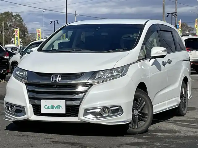 ホンダ オデッセイ アブソルート・EXホンダセンジング 道央・札幌 2017(平29)年 17.3万km ホワイトオーキッドパール ４WD/ワンオーナー/純正メーカーナビ/CD/DVD/BT/フルセグ/純正フリップダウンモニター/ホンダセンシング/衝突被害軽減ブレーキ/横滑り防止装置/アダプティブクルーズコントロール/レーンキープアシスト/パーキングアシスト/ブラインドスポットモニター/全方位カメラ/ビルトインETC/ドライブレコーダー/アイドリングストップ/D席パワーシート/ハーフレザーシート/革巻きステアリング/ステアリングリモコン/パドルシフト/レーダー探知機/プッシュスタート/スマートキー/LEDヘッドライト/オートライト/フォグランプ/電動格納ミラー/ウィンカーミラー/純正フロアマット/ドアバイザー/純正エンジンスターター