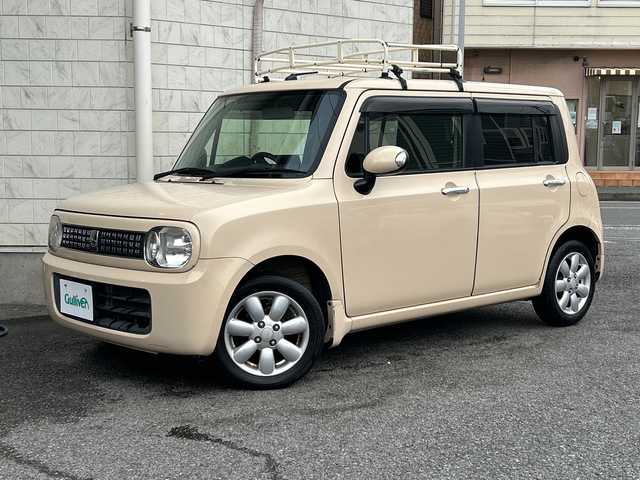 スズキ ラパン X セレクション 神奈川県 2013(平25)年 9.5万km ミルクティーベージュメタリック 社外ナビ/LEDライト/オートライト/純正フロアマット/アイドリングストップ/シートヒーター/ルーフキャリア/純正14インチAW/社外オーディオ/【ラジオ/CD/AUX】/スペアキー/新車時保証書/取扱説明書