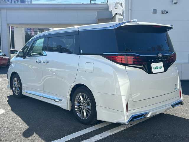 トヨタ アルファードハイブリット Z 東京都 2025(令7)年 1万km プラチナホワイトパールマイカ ワンオーナー/純正フルセグTVナビ/（Bluetooth/HDMI/Type-C/T-Connect）/JBLブレミアムサウンド/純正18インチアルミホイール/純正フロアマット/モデリスタフルエアロ/・フロントスポイラー/・サイドスカート/・リアスポイラー/・ディフーザー/アラウンドビューモニター/バックカメラ/ビルトインETC2.0/レザーシート/・パワーシート/・シートヒーター/・エアシート/デジタルインナーミラー/置くだけ充電/左右独立ムーンルーフ/ハンドルヒーター/追従型クルーズコントロール/パドルシフト/横滑り防止装置/コーナーセンサー（前後）/レーンキープアシスト/オートライト/オートマチックハイビーム/LEDヘッドライト/衝突被害軽減システム/スマートキー/スペアキー1本/保証書