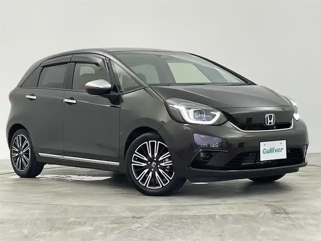 ホンダ フィット e:HEVリュクス 群馬県 2020(令2)年 3.3万km 茶 純正８インチナビ/バックカメラ/アダプティブクルーズコントロール/ドライブレコーダー/ETC/オートハイビーム/シートヒーター/レーンキープアシスト/BT接続/ワイパーデアイサー/盗難防止装置/横滑り防止装置/衝突被害軽減システム/ステアリングリモコン/SRSエアバック （運転席/助手席/サイド/カーテン）/本革シート/純正16インチアルミホイール/禁煙車