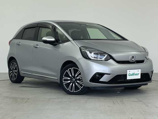 ホンダ フィット e:HEVリュクス 愛知県 2020(令2)年 4.8万km ルナシルバーM ／純正９インチナビ/／ＣＤ　ＤＶＤ　ＢＴ　ＳＤ　ＦＭ　ＡＭ/／フルセグＴＶ/／ホンダコネクト/／バックカメラ/／ETC/／ホンダセンシング/／アダプティブクルーズコントロール/／衝突被害軽減システム/／スマートキー/／スペアキー/／ハーフレザーシート/／前席シートヒーター/／ステアリングヒーター/／前後コーナーセンサー/／純正フロアマット/／電動パーキングブレーキ/／ドアバイザー/／LEDオートヘッドライト/／純正フォグランプ