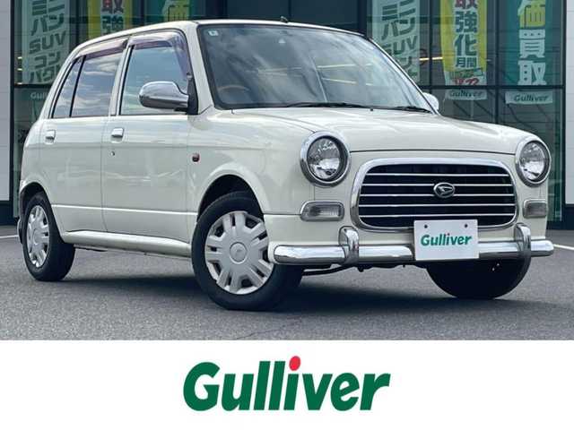 ダイハツ ミラ ジーノ 岡山県 2004(平16)年 15.9万km ホワイトパールマイカ 登録時走行距離：158192km/禁煙車/5速MT/社外オーディオ（DEH-380）/ETC/ブラウンウッドインテリア/ウッドコンピステアリング/ハーフレザーシート/電動格納ミラー/パワーウインドウ/パワーステアリング/メカニカルキー/スペアキー/純正ホイールカバー/取扱説明書/新車時整備手帳（保証書）
