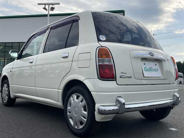 ダイハツ ミラ ジーノ 岡山県 2004(平16)年 15.9万km ホワイトパールマイカ 登録時走行距離：158192km/禁煙車/5速MT/社外オーディオ（DEH-380）/ETC/ブラウンウッドインテリア/ウッドコンピステアリング/ハーフレザーシート/電動格納ミラー/パワーウインドウ/パワーステアリング/メカニカルキー/スペアキー/純正ホイールカバー/取扱説明書/新車時整備手帳（保証書）