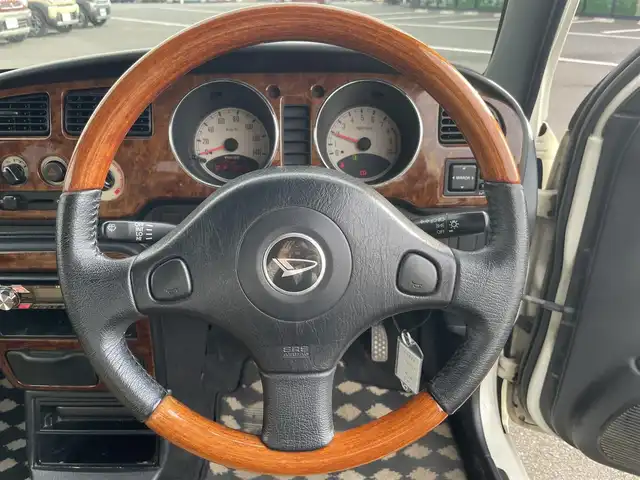 ダイハツ ミラ ジーノ 岡山県 2004(平16)年 15.9万km ホワイトパールマイカ 登録時走行距離：158192km/禁煙車/5速MT/社外オーディオ（DEH-380）/ETC/ブラウンウッドインテリア/ウッドコンピステアリング/ハーフレザーシート/電動格納ミラー/パワーウインドウ/パワーステアリング/メカニカルキー/スペアキー/純正ホイールカバー/取扱説明書/新車時整備手帳（保証書）