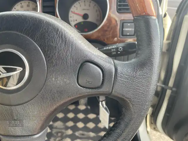 ダイハツ ミラ ジーノ 岡山県 2004(平16)年 15.9万km ホワイトパールマイカ 登録時走行距離：158192km/禁煙車/5速MT/社外オーディオ（DEH-380）/ETC/ブラウンウッドインテリア/ウッドコンピステアリング/ハーフレザーシート/電動格納ミラー/パワーウインドウ/パワーステアリング/メカニカルキー/スペアキー/純正ホイールカバー/取扱説明書/新車時整備手帳（保証書）