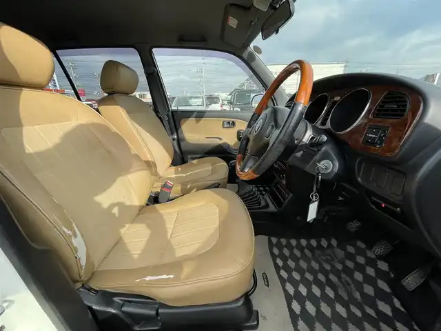 ダイハツ ミラ ジーノ 岡山県 2004(平16)年 15.9万km ホワイトパールマイカ 登録時走行距離：158192km/禁煙車/5速MT/社外オーディオ（DEH-380）/ETC/ブラウンウッドインテリア/ウッドコンピステアリング/ハーフレザーシート/電動格納ミラー/パワーウインドウ/パワーステアリング/メカニカルキー/スペアキー/純正ホイールカバー/取扱説明書/新車時整備手帳（保証書）