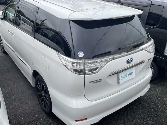 トヨタ エスティマ ハイブリッド アエラス プレミアムエディション 福岡県 2014(平26)年 14万km ホワイトパールクリスタルシャイン 純正7インチナビ/（Bカメラ、TV、CD、Bluetooth、、AUX、AM、FM）/サンルーフ/フリップダウンモニター/リアエアコン/クルコン/両側パワースライドドア/AC100V/フロントワイパーデアイサースイッチ/VTR入力/寒冷地仕様車/車両接近警報/取扱説明書/保証書