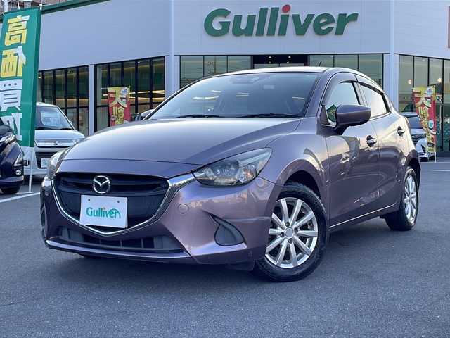 マツダ デミオ 13S 長野県 2014(平26)年 8万km スモーキーローズマイカ 禁煙車/純正ナビ/バックカメラ/ＢｌｕｅｔｏｏｔｈAudio/（ＵＳＢ／ＦＭ／ＡＭ）/社外15インチアルミホイール/ＥＴＣ/ドライブレコーダー/ステアリングスイッチ/アイドリングストップ/オートライト/スマートキー/プッシュスタート/電動格納ミラー/純正フロアマット/HIDライト/横滑り防止/ドアバイザー/Wエアバッグ/ABS