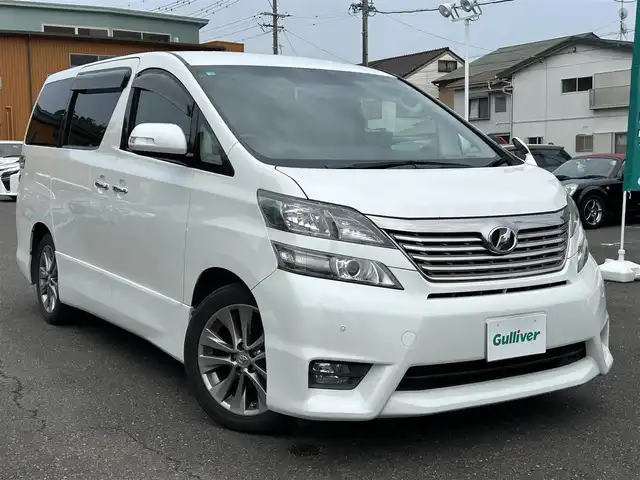 トヨタ ヴェルファイア 2．4Z プラチナセレクションⅡ 静岡県 2010(平22)年 9.4万km ホワイトパールクリスタルシャイン ワンオーナー/社外HDDナビ（VIE-X088）/フルセグTV/DVD/CD/USB/SD/社外フリップダウンモニター/バックカメラ/両側パワースライド/パワーバックドア/純正18インチアルミホイール/ウッドコンビハンドル/HIDライト/ビルトインETC/スマートキー2個/プッシュスタート/新車時保証書