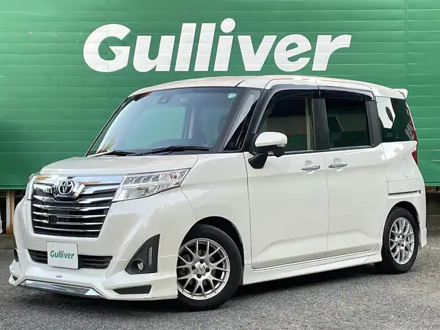 トヨタ ルーミー カスタムG－T 東京都 2017(平29)年 4.9万km パールホワイトⅢ コンフォートパッケージ/・前席シートヒーター/・前席シートバックテーブル/ナビレディパッケージ/・バックカメラ/・ステアリングスイッチ(オーディオ)/モデリスタエアロ　フロント/リアスカート/リアスポイラー/9型メモリナビ(ALPINE　X9V)/社外アンプ　(ALPINE　3553)/ターボ車/クルーズコントロール/スマートアシスト2(衝突回避支援システム)/・衝突回避支援ブレーキ機能/・衝突警報機能/・車線逸脱警報機能/・誤発進抑制制御機能/・先行者発進お知らせ機能/前後方ドライブレコーダー(ZDR015)/両側パワースライドドア/LEDヘッドライト/マルチインフォメーションディスプレイ/スペアキー×1/保証書/取扱説明書