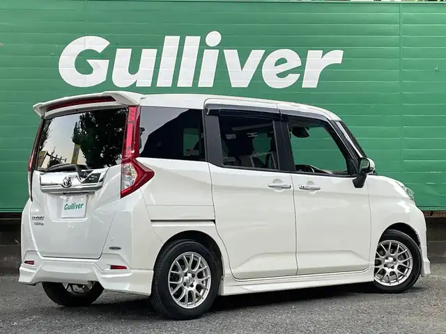 トヨタ ルーミー カスタムG－T 東京都 2017(平29)年 4.9万km パールホワイトⅢ コンフォートパッケージ/・前席シートヒーター/・前席シートバックテーブル/ナビレディパッケージ/・バックカメラ/・ステアリングスイッチ(オーディオ)/モデリスタエアロ　フロント/リアスカート/リアスポイラー/9型メモリナビ(ALPINE　X9V)/社外アンプ　(ALPINE　3553)/ターボ車/クルーズコントロール/スマートアシスト2(衝突回避支援システム)/・衝突回避支援ブレーキ機能/・衝突警報機能/・車線逸脱警報機能/・誤発進抑制制御機能/・先行者発進お知らせ機能/前後方ドライブレコーダー(ZDR015)/両側パワースライドドア/LEDヘッドライト/マルチインフォメーションディスプレイ/スペアキー×1/保証書/取扱説明書