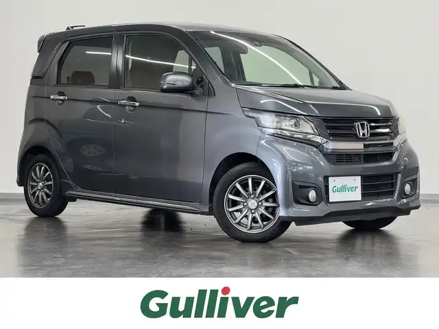 ホンダ Ｎ ＷＧＮ カスタム G ターボパッケージ 三重県 2014(平26)年 1.3万km ポリッシュドメタルメタリック ガソリン・ターボ/FF/MTモード付インパネCVT/純正 7インチナビ VXM-145C/（FM/AM/CD/USB/iPod/SD/VTR/AUX）/バックカメラ/安全/・近距離衝突軽減ブレーキ［CTBA］/・VSA（ABS＋TCS＋横すべり抑制）/・SRS サイド＆カーテンエアバッグ/装備/・ハーフレザーシート/・クルーズコントロール/・パドルシフト/・オートエアコン/・オートライト/・キセノンヘッドライト/・フロントフォグランプ/・ステアリングスイッチ/・電動格納ドアミラー（ウインカー付）/・純正14inAW/・プッシュスタート/・スマートキーx2/・本革巻きステアリング/・リアシートベルトインジケータ付きインナーミラー/など