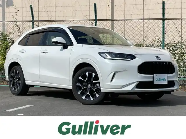 ホンダ ＺＲ－Ｖ ハイブリッド e:HEV Z 東京都 2024(令6)年 1.8万km プラチナホワイトパール 純正９型ワイドディスプレィオーディオナビ/・BluetoothAudio　/・AppleCarPlay＆AndroidoAuto/・AM/FM/フルセグ/BOSEサウンドシステム /アラウンドビューモニター /全席レザーシート/・前席シートヒーター /・Dメモリパワーシート/・前席パワーシート/ブラインドスポットモニター /前後ドライブレコーダー /おくだけ充電 /ステアリングヒーター/LEDヘッドランプ/ホンダセンシング/（予防運転支援システム）/・衝突軽減ブレーキ/・後方誤発進抑制機能/・歩行者事故低減ステアリング/・追従機能付きクルーズコントロール/・車線維持支援システム/・標識認識機能/・後退時出庫サポート/・パーキングセンサーシステム/プッシュエンジンスタート/純正フロアマット/スマートキー/保証書＆取説