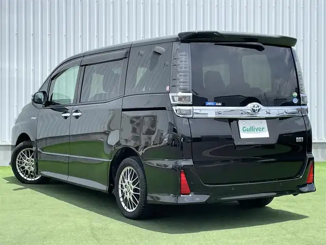 トヨタ ヴォクシー ハイブリッド ZS 煌Ⅱ 香川県 2019(平31)年 2.5万km イナズマスパーキングブラックガラスフレーク 登録時走行距離：24326km/バックカメラ/前方ドライブレコーダー/革巻きステアリング/ステアリングリモコン/クルーズコントロール/前席シートヒーター/ビルトインETC/LEDオートライト/オートハイビーム/電格ウィンカーミラー/両側パワースライド/USB充電/純正16インチアルミホイール/純正マット/スペアキー1本/後部座席サンシェイド/プリクラッシュセーフティー/パーキングサポートブレーキ/スペアキー1本