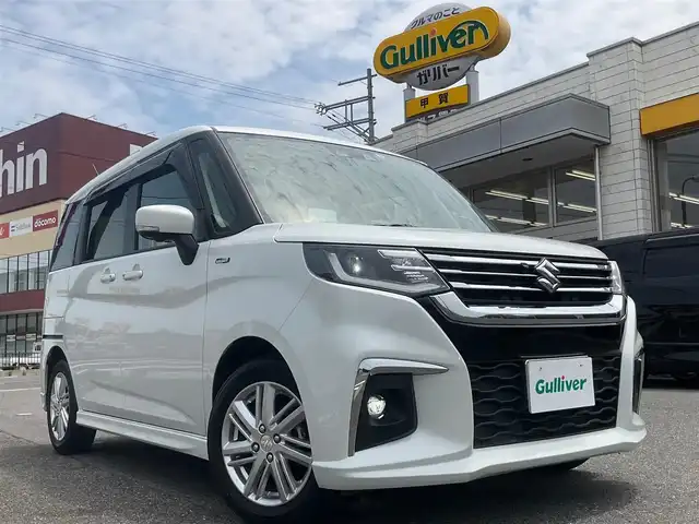 スズキ ソリオ HV MZ 滋賀県 2022(令4)年 3.6万km ピュアホワイトP 全方位モニター付ナビ装着車/ワンオーナー /純正15インチアルミホイール/両側パワースライドドア/純正メーカーOP9インチナビゲーション/・CD/DVD/・AM/FM/・Bluetooth/全方位モニター/純正ETC/ヘッドアップディスプレイ/前後ドライブレコーダー/前席シートヒーター/クルーズコントロール/スペアキー/取扱説明書/保証書/