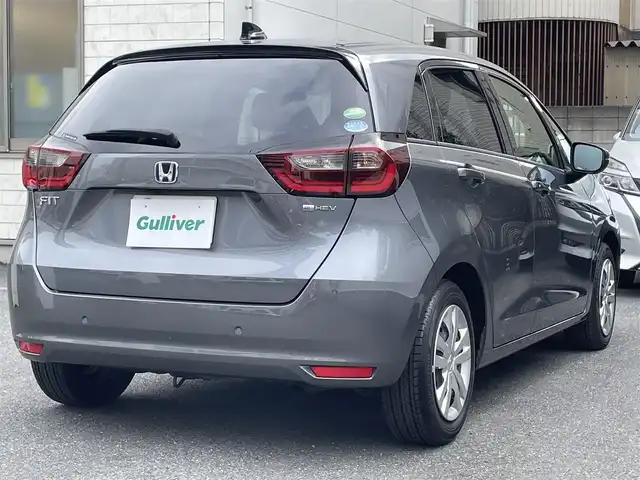 ホンダ フィット e:HEVホーム 埼玉県 2021(令3)年 7万km シャイニンググレーM 登録時69378km/純正９インチナビ（BT/フルセグ）/バックカメラ/衝突軽減ブレーキ/路外逸脱制御機能/踏み間違い衝突軽減システム/レーダークルーズコントロール/パーキングセンサー/前後ドライブレコーダー/プッシュスタート/スマートキー×２/ビルトインETC/ハーフレザーシート/革巻きハンドル/ステアリングリモコン/オートライト/純正LEDヘッドライト/ウインカーミラー/横滑り防止装置/フロアマット/スタットレスタイヤ４本積込/保証書/取扱説明書/ナビ取扱説明書