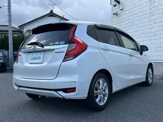 ホンダ フィット ハイブリット L ホンダセンシング 山形県 2018(平30)年 8.7万km プレミアムホワイトパールⅡ 禁煙車/純正SDナビ/・TV/AM/FM/CD/DVD/アダプティブクルーズコントロール/アイドリングストップ/レーンキープアシスト/衝突被害軽減ブレーキ/標識認識機能/車線逸脱警報/先行車発進お知らせ/横滑り防止装置/LEDヘッドライト/オートライト/フロントフォグランプ/ハーフレザーシート/バックカメラ/純正フロアマット/純正ドアバイザー/ETC/冬タイヤ積み込み/保証書/取扱説明書