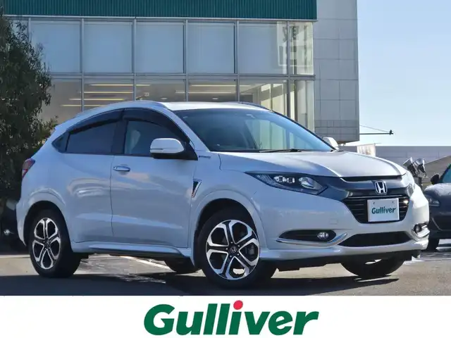 ホンダ ヴェゼル ハイブリッド Z 鹿児島県 2014(平26)年 5.6万km ホワイトオーキッドパール アダプティブクルーズコントロール　/パドルシフト　/ＥＴＣ　/社外ＳＤナビ（ＭＤＶ－Ｚ７０１）　/Ｂｌｕｅｔｏｏｔｈオーディオ　/フルセグテレビ　/バックカメラ　/ＭＴモード付きＡＴ　/Ｄ＋Ｎ席ヒートシーター/ハーフレザーシート/アルミルーフレール/LEDヘッドライト/純正アルミホイール(17インチ)/横滑り防止装置/プッシュスタート/スマートキー/エアバック(W+サイド)/カーテンエアバッグ