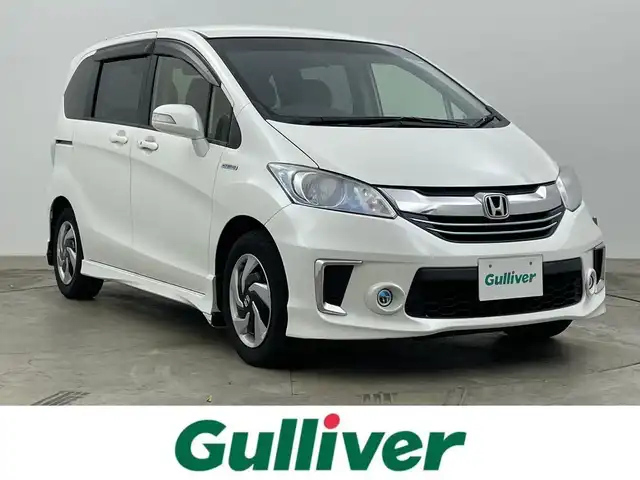 ホンダ フリード ハイブリット プレミアムエディション 岡山県 2016(平28)年 6.8万km ホワイトオーキッドパール 純正メモリナビゲーション/(CD/DVD/SD/BT/USB/ワンセグTV)/バックカメラ/ビルトインETC/社外ドライブレコーダー前後/ハーフレザーシート/両側パワースライドドア/スマートキー×2/ステアリングリモコン/チルトステアリング/クルーズコントロール/シートリフター/HIDヘッドライト/フォグランプ/横滑り防止/ISOFIX/純正フロアマット/純正リアスポイラー/保証書/取扱説明書
