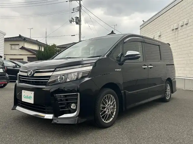 トヨタ ヴォクシー ハイブリッド ZS 煌Ⅱ 山形県 2016(平28)年 10.8万km ブラック 純正10インチナビ/FM/AM/フルセグ/Bluetooth/衝突軽減ブレーキ/車線逸脱防止/両側パワースライドア/純正バイザー/純正マット/LEDライト/フォグランプ/スペアキー/スマートキー/アルミ付きスタッドレスタイヤ積載